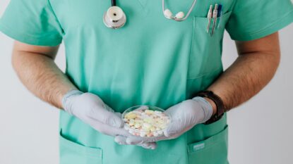 Doctor holding pills